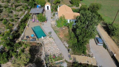 an aerial view of a house with a swimming pool at Dorinda in Agia Marina
