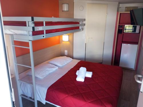 a bedroom with a bunk bed with two towels at Premiere Classe Soissons in Soissons