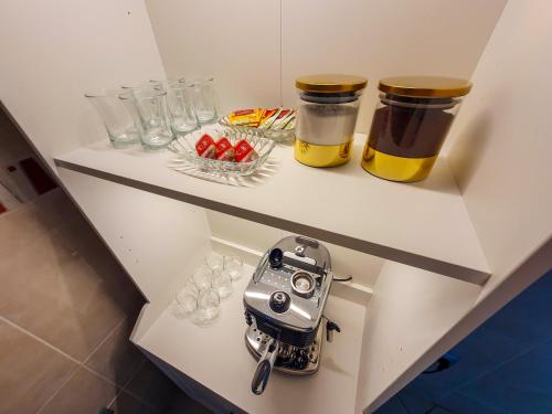 a shelf with glasses and a camera on it at Apartment for rent with 3 bedrooms in Tangier