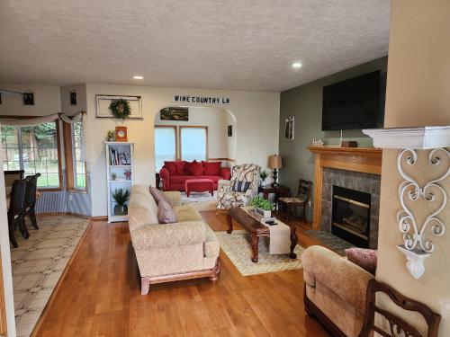 a living room with a red couch and a fireplace at A Wine Country Home in Yamhill County in Lafayette