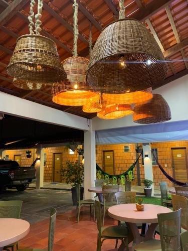 a restaurant with tables and chairs and baskets at POUSADA DOS LAGOS in Paulino Neves