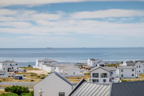 a town with houses and the ocean in the background at Forever Blue in St Helena Bay
