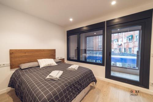 a bedroom with a bed with two towels on it at Castilla Luxury 1B Apartment in Madrid
