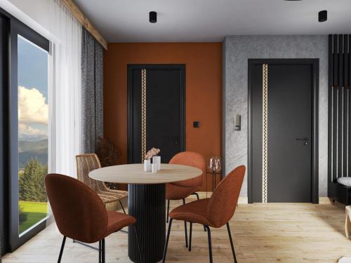 a dining room with a table and chairs and a window at Alpina Residence & Kameralne SPA in Bukowina Tatrzańska