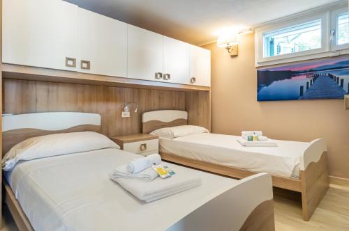 a room with two beds and a painting on the wall at Golfo dei Poeti! Tellaro Holiday Home in Tellaro