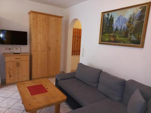 a living room with a couch and a table at Scheffauerhof in Scheffau am Wilden Kaiser