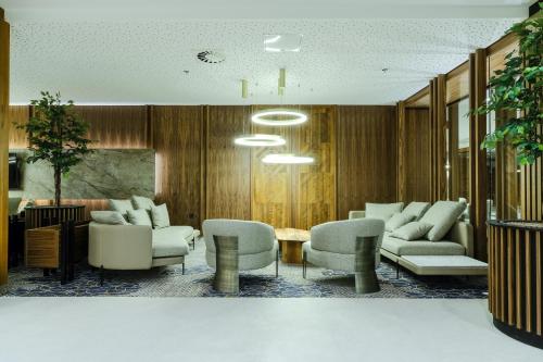 a lobby with couches and chairs and a table at Hotel Vema in Visoko