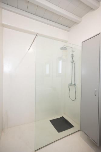 a shower with a glass door in a bathroom at Private Villa Màou in Ano Mera