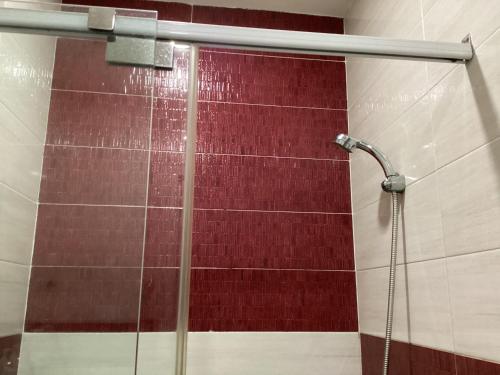 a shower with a glass door in a bathroom at KEIRA s HOUSE in Ho Chi Minh City