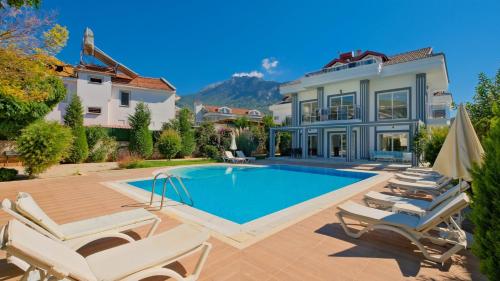 a swimming pool in the backyard of a house at Orka Crystal Villa in Oludeniz