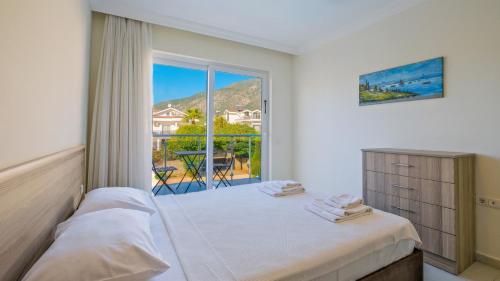 a bedroom with a bed and a large window at Orka Crystal Villa in Oludeniz