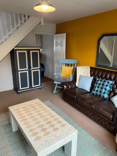 a living room with a couch and a coffee table at Goodwins' by Spires Accommodation a comfortable place to stay close to Burton-upon-Trent in Swadlincote