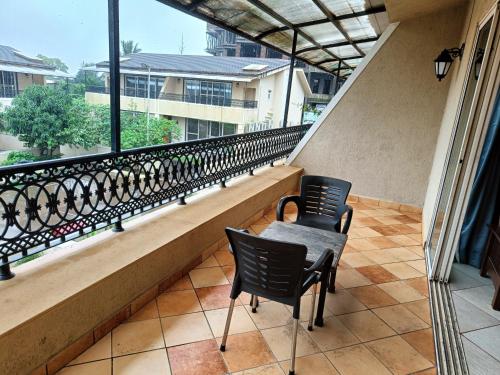 a balcony with two chairs and a balcony railing at Misty Meadows, Lonavala in Lonavala