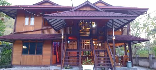 a large wooden house with a staircase leading up to it at HOTEL BESAR BULAN BARU - Senggigi in Senggigi 