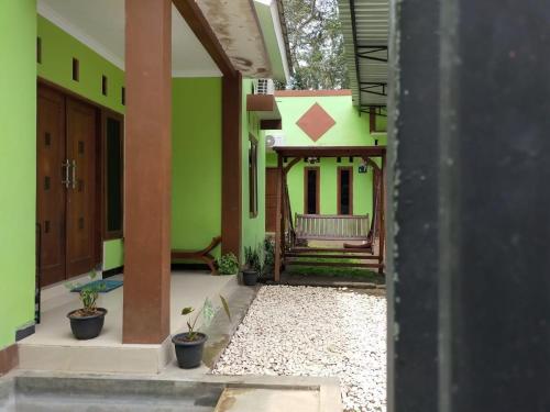 a view of a house with green walls at Mamora Guest House in Kalasan