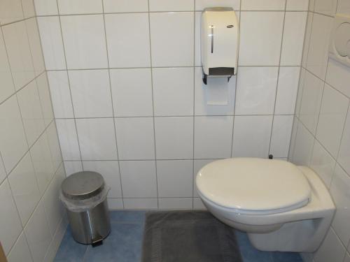 a bathroom with a toilet and a trash can at Gasthaus Adler in Wangen im Allgäu