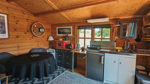 a kitchen with a table and a sink in a room at Ferme de Bourras in La Palud-sur-Verdon