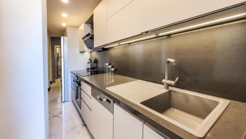 a kitchen with a sink and a counter at Yalikavak Superior Duplex Villa in Bodrum City