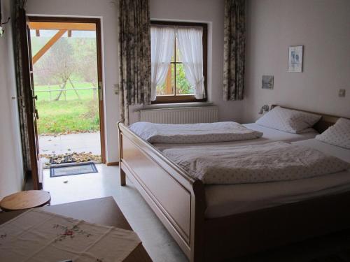 two beds in a bedroom with a window at Gasthaus Adler in Wangen im Allgäu