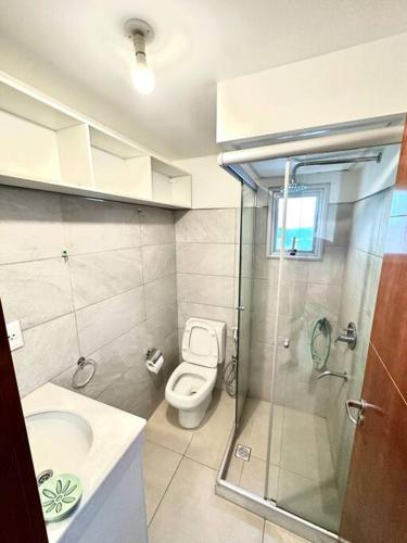 y baño con aseo, ducha y lavamanos. en Hermoso Loft Zona Shopping Sol 03, en Asunción