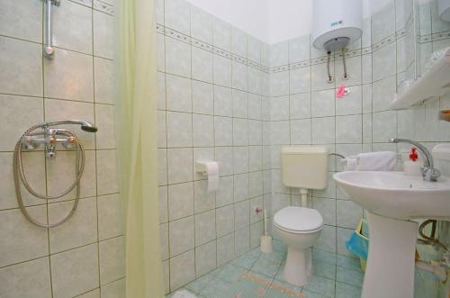 a small bathroom with a toilet and a sink at Apartments and Rooms Barbara in Lastovo