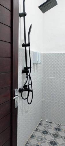 a shower with a bike rack in a bathroom at Giri Swari Homestay in Sidemen
