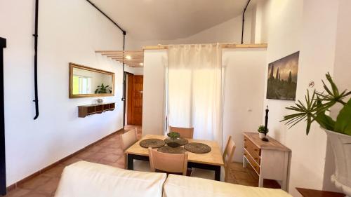 a living room with a table and a couch at ALCAMAR Brand apartment with 2 bedroom and private bathroom near the sea! in Alcalá