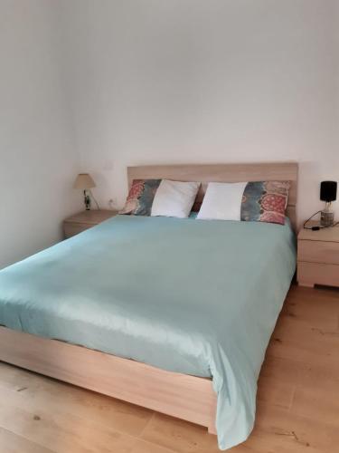 a bedroom with a large bed and two night stands at Maison Paola in Giulianova