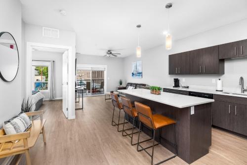 an open kitchen and living room with a counter and chairs at Lincoln Park Boutique Hotel in Duluth