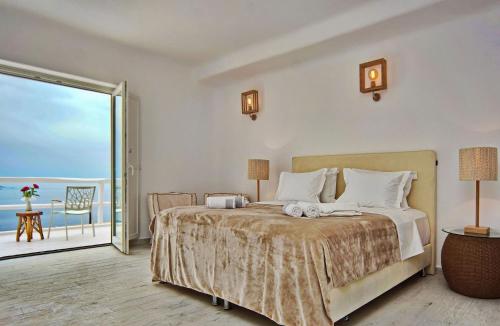 Schlafzimmer mit einem Bett und Meerblick in der Unterkunft Magnificent Mykonos Villa - Villa Blue Paradise - 8 Bedroom - Private Pool And Bar - Panoramic SeaViews in Fanari