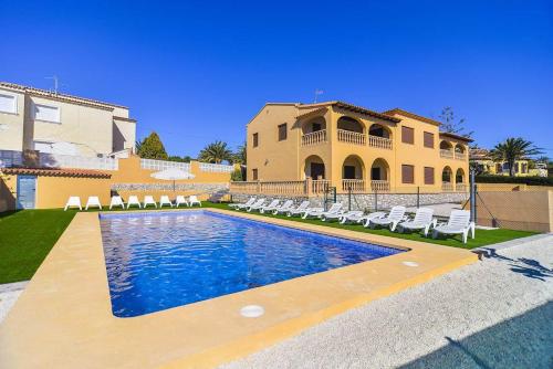 a villa with a swimming pool in front of a house at Villa Ambar - PlusHolidays in Calpe