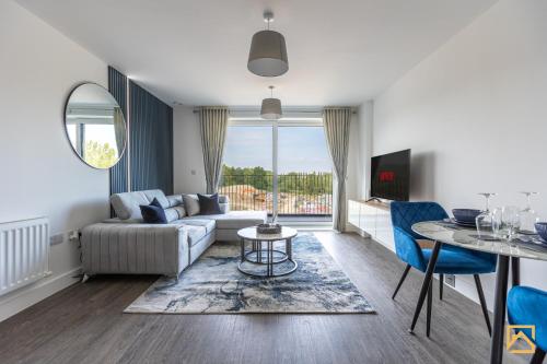 a living room with a couch and a table at Cosy 1 bed near peaceful canal By Valore Property Services in Milton Keynes