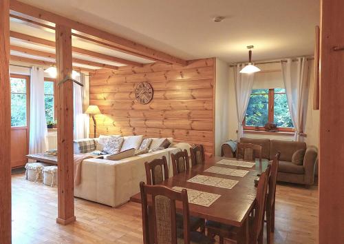 a living room with a couch and a table at Dębowa Dziupla in Białowieża