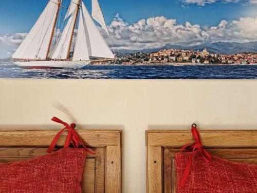 a painting of a sail boat on the water at A Baracca du Pei in Imperia