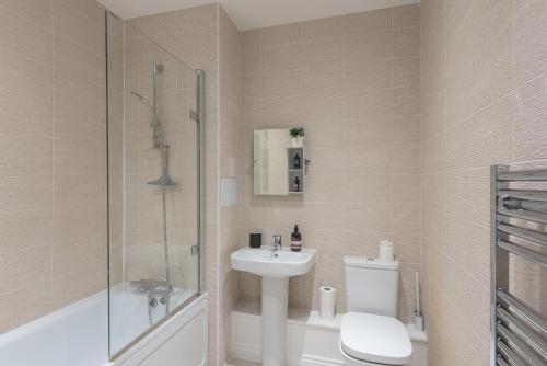 a bathroom with a toilet and a sink and a shower at Central 1-Bed perfect for you By Valore Property Services in Milton Keynes