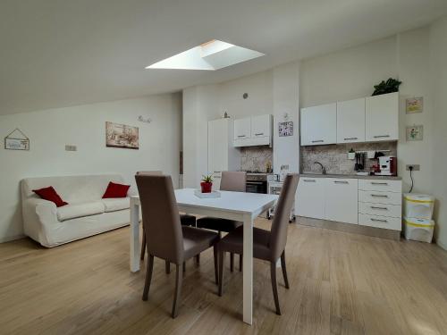 a kitchen and living room with a table and chairs at Villa Rosa in Latronico