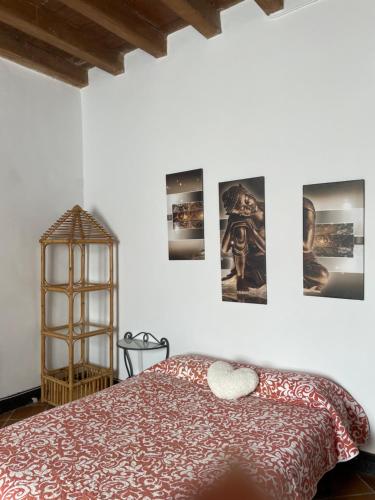 a bedroom with a bed and pictures on the wall at Casa Rural para descansar piscina cerca in Osor