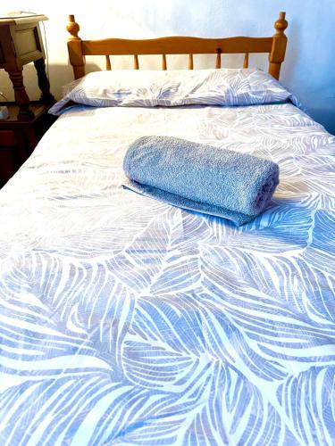 a blue and white bedspread with a pillow on it at Casa Rural para descansar piscina cerca in Osor