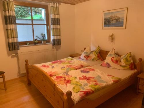 a bedroom with a bed with a comforter and a window at Haus Ulli in Radstadt