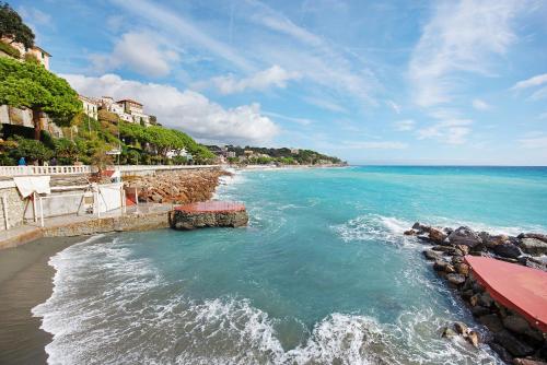 a view of a beach with the ocean and buildings at Dai Baccino in Celle Ligure