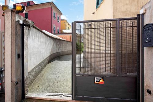 an open door with a gate in a street at Dai Baccino in Celle Ligure