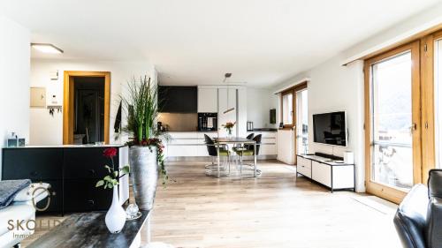 a living room with a kitchen and a dining room at Haus Enzian, Blitzingen in Blitzingen