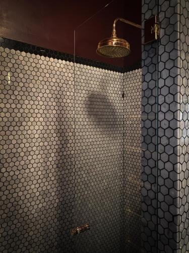 a bathroom with a shower with a glass door at The House in Strevi