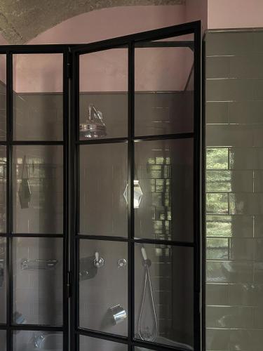 a glass cabinet with a sink in a bathroom at The House in Strevi