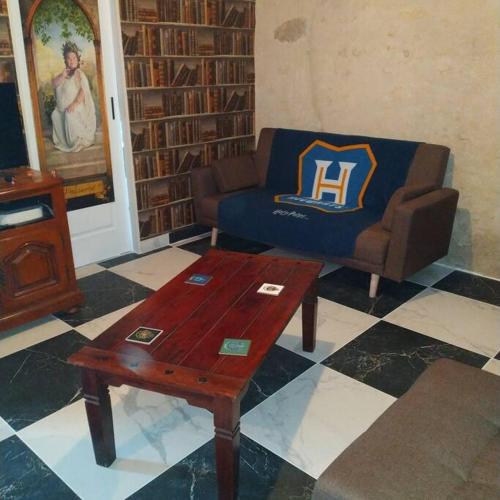 a living room with a couch and a coffee table at Le Petit Gite des sorciers, Chitray, Indre in Chitray