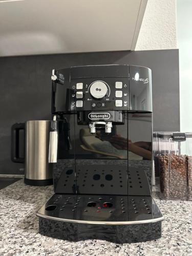 a black coffee maker sitting on top of a counter at Wohnung in Laupheim in Laupheim