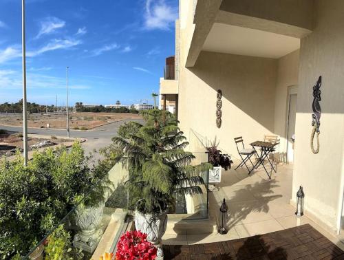 a balcony of a building with a view of a street at Vague Bleue chez Makuja Home in Bouznika