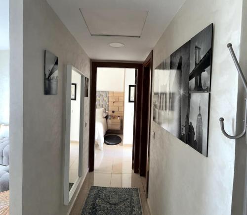a hallway leading to a bedroom with white walls at Vague Bleue chez Makuja Home in Bouznika