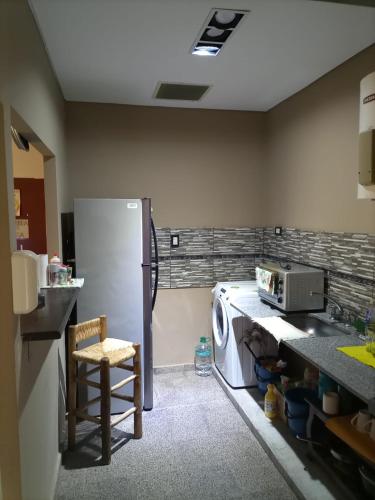 a kitchen with a refrigerator and a washing machine at Casa Norte in La Rioja