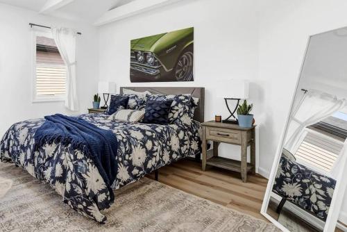 a bedroom with a bed with a blue and white comforter at Cool Urban Stay Downtown Loft in Buffalo